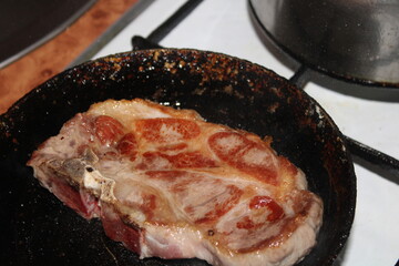 steak is fried in a pan