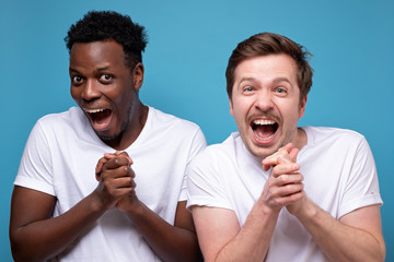 men are shocked, they open their mouths in amazement and look at the camera saying wow.