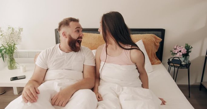 Cute Couple Overslept, Panicking And Screaming With Big Eyes . Funny Man And Woman Waking Up, Realizing That They Are Late And Quickly Getting Out Of Bed .Concept Of Lifestyle.