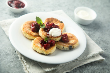 Homemade cottage cheese cakes with cherry sauce