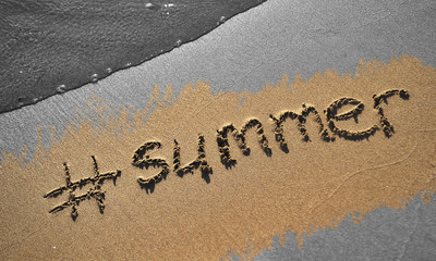 Conceptual photo of quarantine on vacation. The word Summer written on sand.