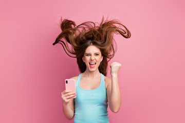 Portrait of her she nice attractive lovely charming successful cheerful cheery straight-haired girl using device having fun ideal silky hair flying isolated on pink pastel color background