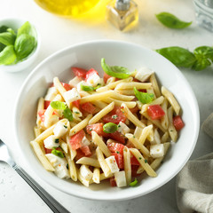 Pasta salad with tomato, mozzarella and basil