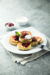 Homemade cottage cheese cakes with cherry sauce