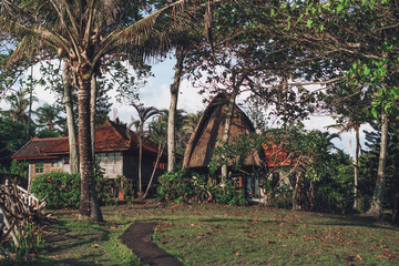 ancient gazebo with roof standing with green trees