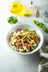Pasta salad with tomato, mozzarella and basil