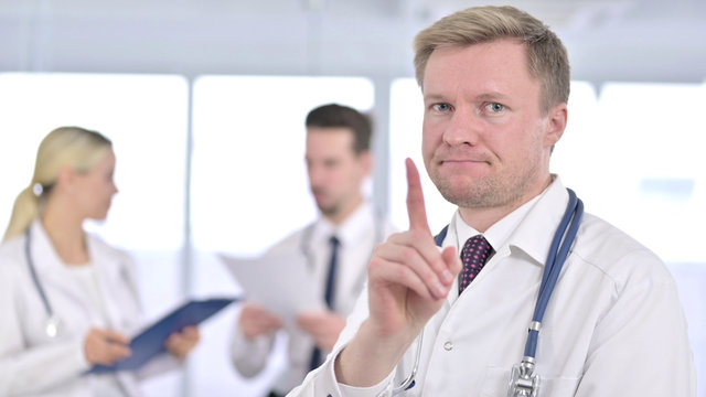 Serious Male Doctor Saying No By Finger Sign