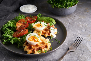 Healthy organic breakfast. Waffles, herbs, tomatoes,salad,eggs, spices served in a plate