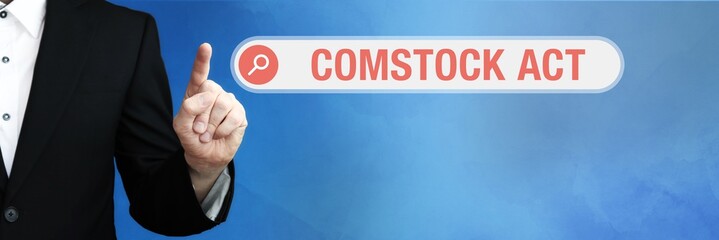 Comstock Act. Lawyer in suit points with his finger to a search box. The term Comstock Act is in focus. Concept for law, justice, jurisprudence