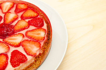 Delicious homemade strawberry tart. Isolated on wooden background. Top view. Copy space. Close-up. Horizontal shot.