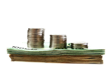 stacks of coins on a stack of euro banknotes isolated on a white background. Side view. Money...