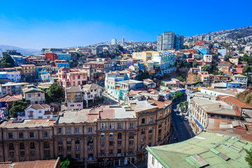 Fototapeta premium Panoramic View to the Mountain Hills with the Colorful and Bright Buildings with Painting, Valparaiso, Chile 