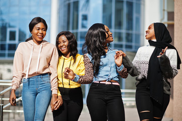 Four young college african american woman friends spend time together.