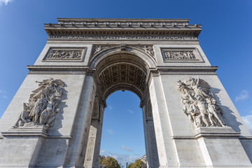 Looking up at the Arc de Triomphe in Paris France with clear blue sky