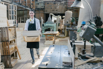 Confident woman working as carpenter in her own woodshop