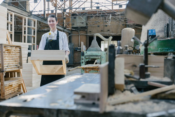 Confident woman working as carpenter in her own woodshop