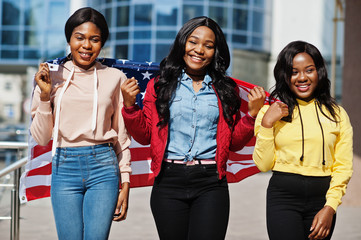 Three young college african american womans friends with flag of USA.
