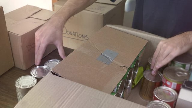 Close up of man preparing box of donations