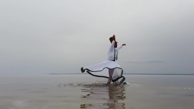 sunset and whirling at the sea, sufi. sufi whirling (Turkish: Semazen) is a form of Sama or physically active meditation which originated among Sufis. 4k