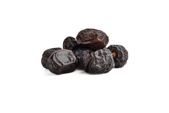 Ajwa Dates fruits or dry dates isolated on white background.Ramadan Kareem Breaking the fast by eating Tamar Dates