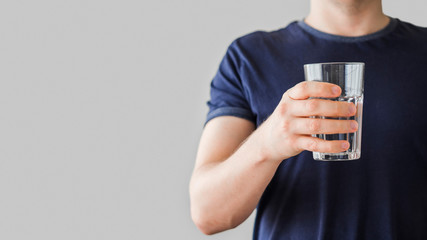 Close-up man holding glass of water