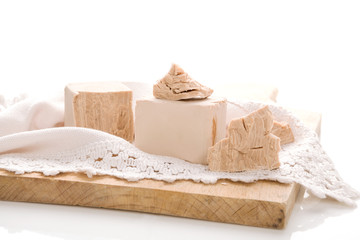 Fresh yeast blocks on wooden board.