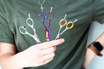 a hairdresser holding scissors in hands