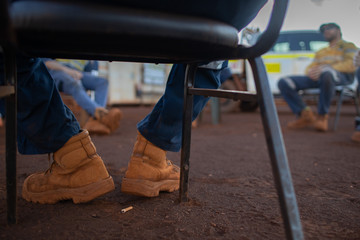 Safety workplace side view clear pic of construction worker safety boot setting on the chair...