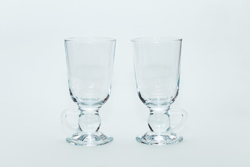 Two empty glasses for mulled wine on a white background