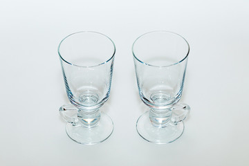 Two empty glasses for mulled wine on a white background