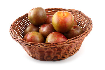 Plums on wicker plate