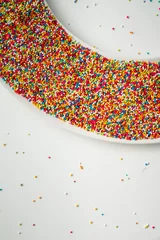 Fototapeten Colourful Sugar sprinkles, decoration for cake and ice-cream and cookies. Top view, Flat lay on white background. © ellinnur