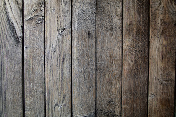 Old table top with brown concrete block wall in dark room background.