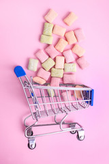 Pillows of multi-colored chewing gum in a supermarket cart