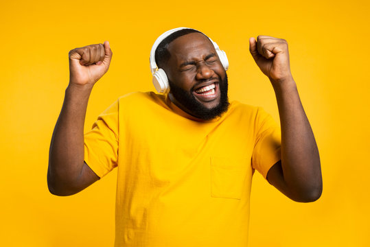 Black Man With Headphones Dancing. Happiness, Yellow Day.