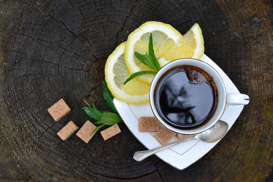 White cup of coffee with lemom and sugar 