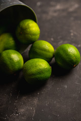Juicy green limes on the rustic background. Selective focus. Shallow depth of field.