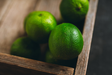 Juicy green limes on the rustic background. Selective focus. Shallow depth of field.