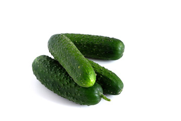 Green cucumbers on a white background. Vegetables