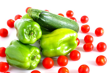 green pepper, zucchini and tomatoes on a white background