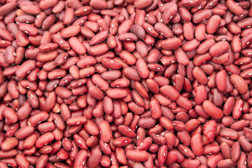 Red beans on fruit vegetables street market pattern as background, close up photo