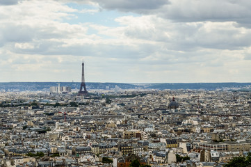 Paris skyline, view from the Sacre Coeur on Montmartre hill, France. Basilica of Sacre Coeur is one of the landmarks in Paris. Aerial view of Paris in summer. Panorama of Paris city on a cloudy day.