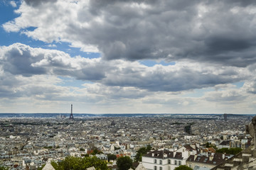 Paris skyline, view from the Sacre Coeur on Montmartre hill, France. Basilica of Sacre Coeur is one of the landmarks in Paris. Aerial view of Paris in summer. Panorama of Paris city on a cloudy day.