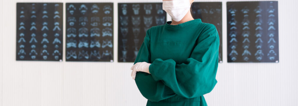 A Female Doctor In A Medical Mask With X-ray Film On Background