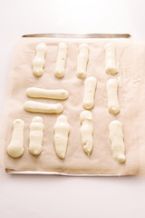 Preparation of savoiardi biscuits , step by steps visual recipe, savoiardi biscuits are lined up on an oven plate over cooking paper and cooked in oven for 12 minutes