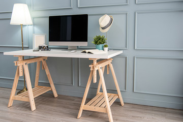 Modern interior. Comfortable workplace. Wooden table with beautiful and computer
