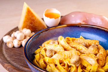 cooked pasta in a plate on a wooden board in the studio