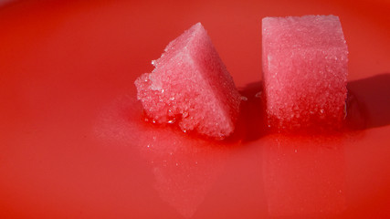 sugar cubes melt in red water