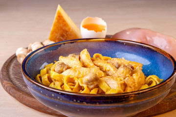 cooked pasta in a plate on a wooden board in the studio