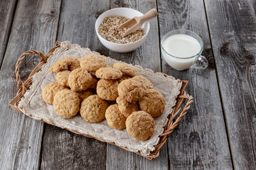 Oatmeal cookies with a jug of milk. On a wooden background.
